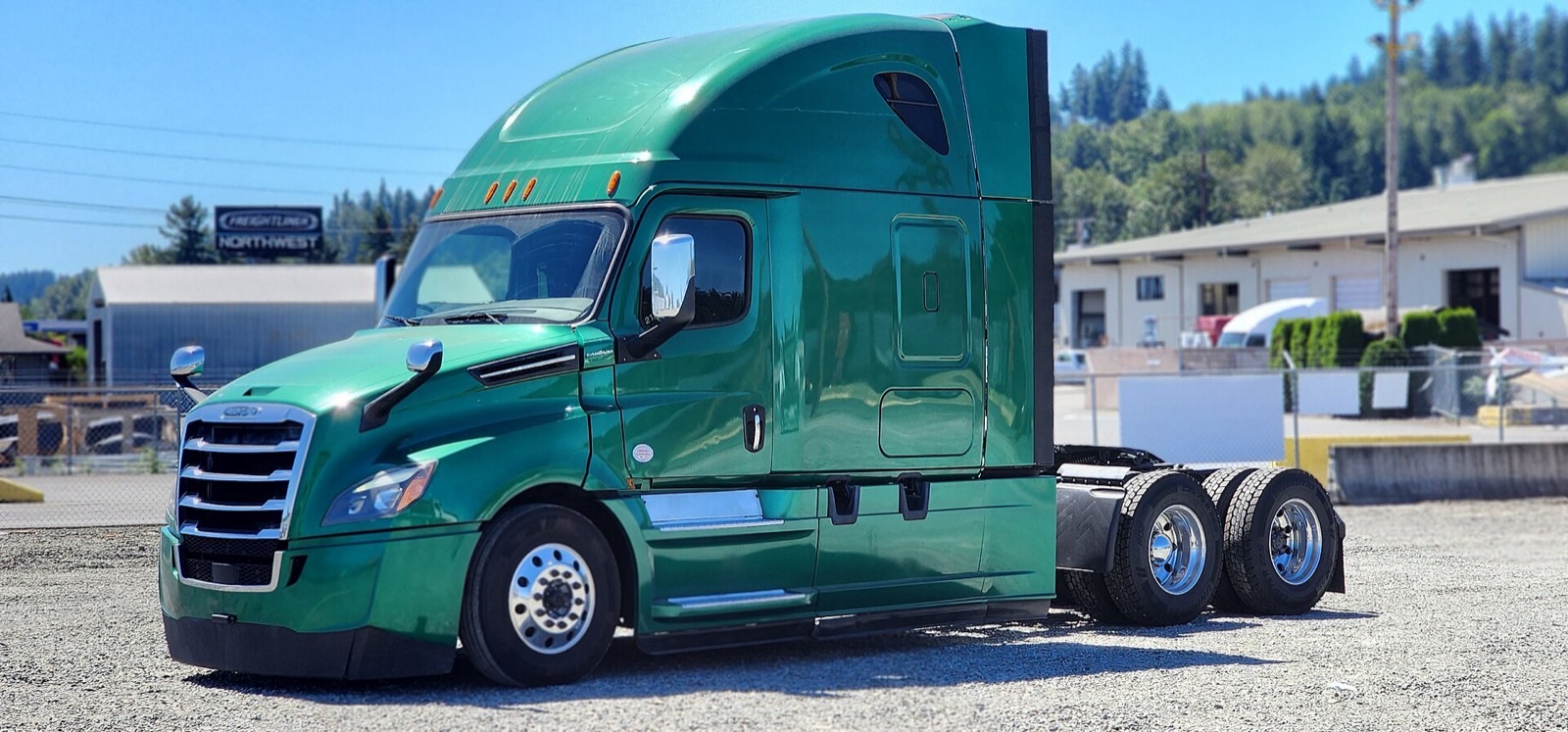 Green 2020 Freightliner Cascadia sleeper-cab semi tractor without a trailer, parked on a gravel lot.