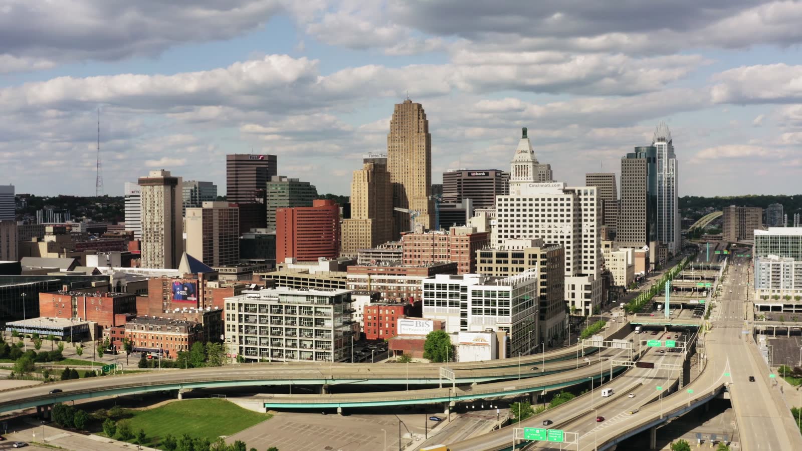 Aerial view of traffic on the elevated freeway ramps in front of downtown Cincinnati, Ohio, on a sunny day.